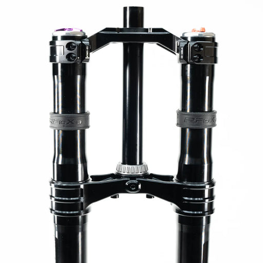 Black dual mountain bike suspension fork with clamps and adjustment knobs.