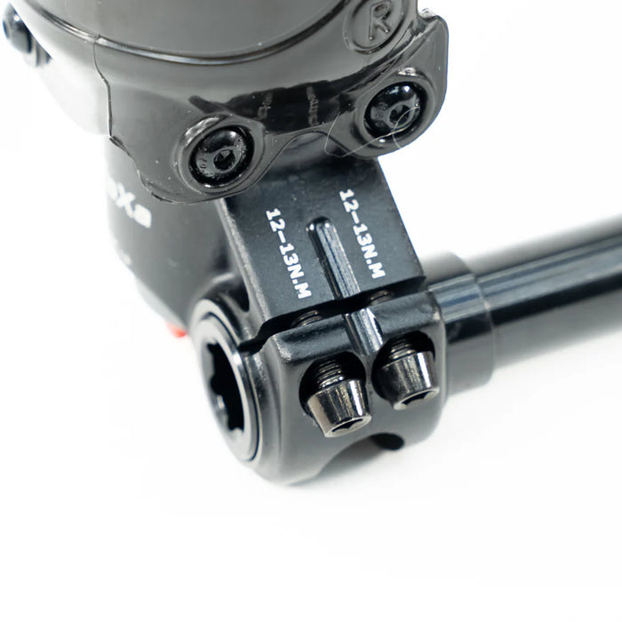 Close-up of black bicycle stem clamp with torque specifications on white background.