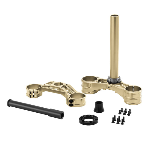 Gold motorcycle triple tree clamp parts with black screws and spacers on white.